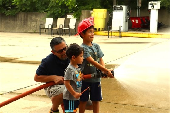 Children playing with a hose at the Public Safety Open House
